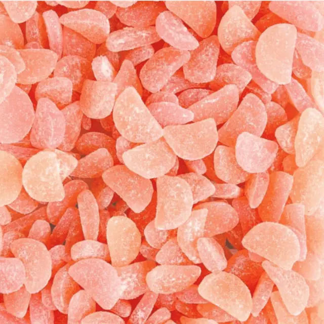 Orange and pink sugar-coated gummies shaped like melon wedges