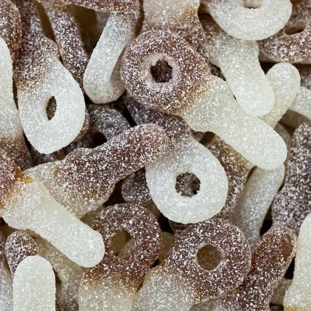 Brown and white sugar-coated gummies shaped like pacifiers