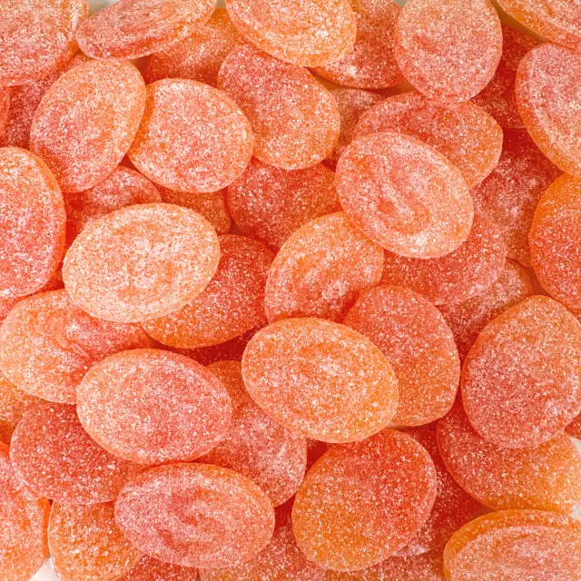 Orange sugar-coated peach candies stamped with an S
