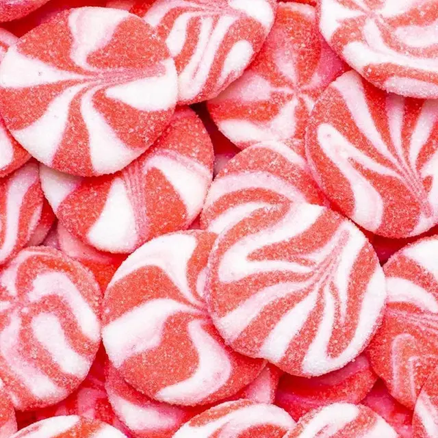 A pile of red and white swirled round jelly candies