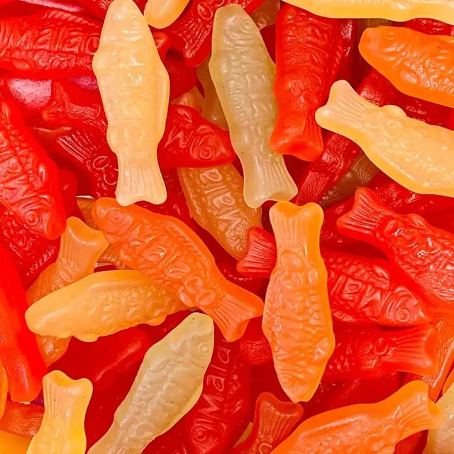 Red, orange, and yellow fish-shaped chewy candies stamped Malaco