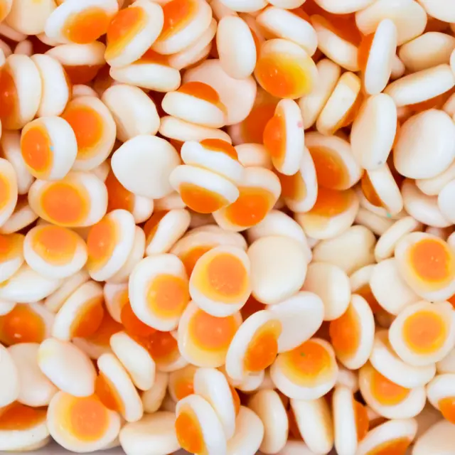Mini white fried-egg gummies with orange centers