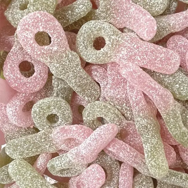 Pink and green sugar-coated pacifier-shaped candies