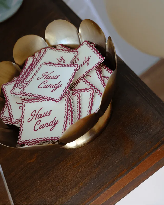 Scalloped Haus Candy stickers in a gold flower-shaped bowl