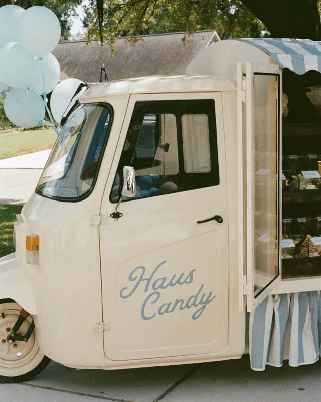 The Haus Candy Cart cab with its blue script logo and pale blue balloons