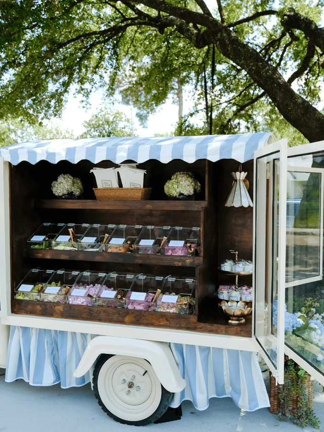 Open Haus Candy Cart with two rows of candy bins beneath a blue-and-white striped awning